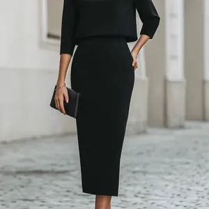 Elegant black two-piece set featuring a long-sleeved top and a midi pencil skirt.