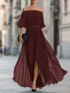 View of the flowing dark red pleated chiffon skirt and off-shoulder neckline on model