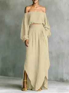 Detail of elegant beige off-shoulder crop top and irregular hem maxi skirt set