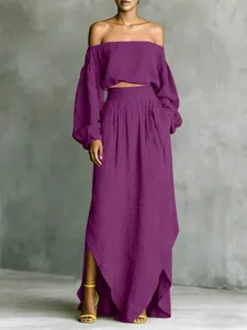Detail of the elegant purple two-piece set featuring off-shoulder top and long skirt