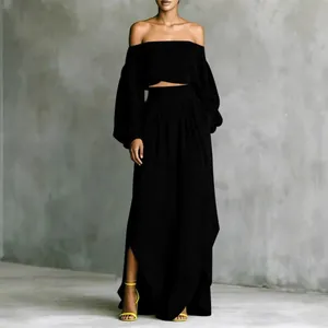 Elegant black two-piece set featuring off-shoulder puff sleeve top and irregular maxi skirt
