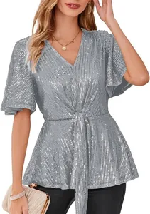 Detailed view of sparkly silver sequin top with V-neck and elegant bell sleeves