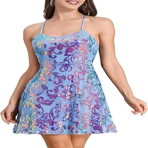 Elegant blue sequined cocktail mini dress featuring intricate purple floral patterns on model