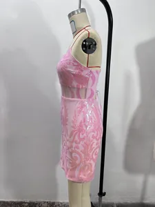Detailed side view of a pink sequin bodycon mini dress with mesh cutouts on a mannequin.