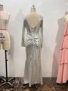 Vista detallada del vestido de noche de lentejuelas plateadas sin espalda con mangas largas.