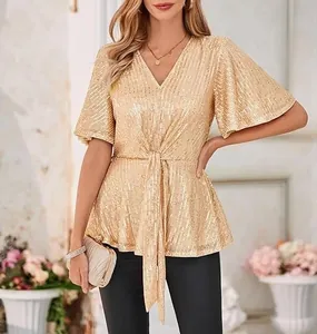 Elegant detail of gold sequin V-neck top with flutter sleeves for evening party wear.