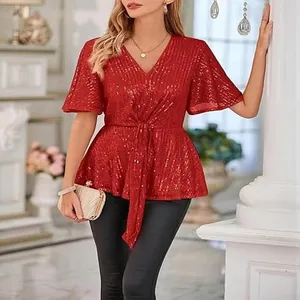 Close-up of red sequined V-neck party blouse with flared sleeves and knot detail