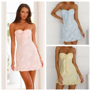 Chic strapless mini dresses in pastel pink, blue and yellow with 3D floral textures.