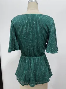 Back view of emerald green sequin party top with flare sleeves and elastic waist