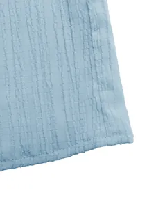 Close-up of light blue textured fabric detail on a summer A-line midi skirt