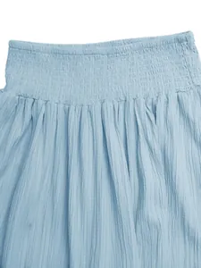 Close-up detail of light blue smocked waist skirt featuring textured crinkle fabric