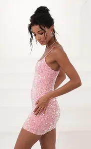 Detailed side view of a shimmering pink sequin bodycon mini dress with thin spaghetti straps