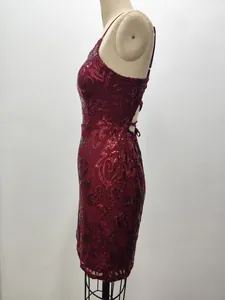 Close-up detail of the side profile of a burgundy sequin party dress on a dress form