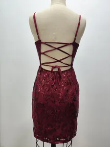 Detail view of a burgundy sequin party dress with elegant lace-up back design.
