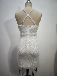 Detailed back view of a white sequin bodycon dress featuring thin cross back straps