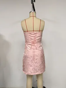 Back view of a pink floral strapless mini dress with elegant lace-up corset detail