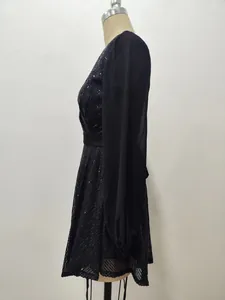 Side view detail of black sequin dress with long sheer chiffon sleeves on mannequin.