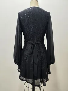 Detailed back view of a black sequined party dress with an elegant waist bow tie