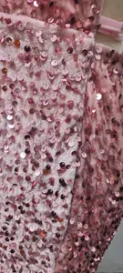 Detailed macro view of pink velvet fabric with sparkling sequins for women's dress