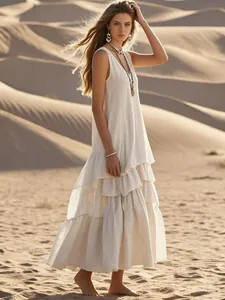 Detailed view of white bohemian linen maxi dress with tiered ruffles in desert setting