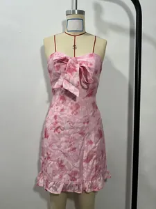 Detailed view of a pink floral bandeau mini dress featuring a large bow on mannequin
