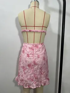Detailed back view of a pink floral bandeau mini dress featuring feminine ruffle hem