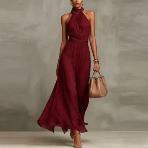 Detail of elegant burgundy halterneck chiffon maxi dress with pleated waist design.