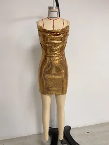 Detailed view of a sparkling gold sequin mini dress with elegant spaghetti straps