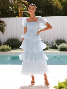 Elegante vestido maxi azul claro con volantes y mangas abullonadas vista piscina