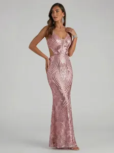Full length view of a pink sequined mermaid evening dress with side cut-out design.