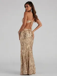 Elegant gold sequined evening gown with intricate backless detail and thin straps.