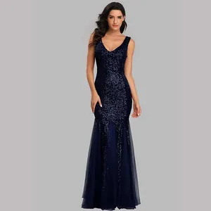 Detail view of navy blue sequined mermaid evening gown with deep V-neck and tulle flare
