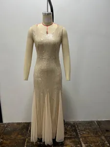 Detailed front view of a beige sequined mermaid evening gown with layered tulle hem.