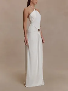 Detailed full-length view of an elegant white halter maxi dress with gathered waist detailing.