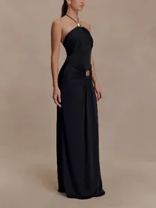 Side view of an elegant black halter neck maxi dress featuring a gold hardware detail