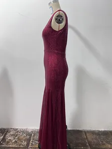 Side detail view of a burgundy sequined mermaid evening gown displayed on a mannequin.