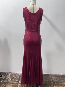 Detailed back view of a burgundy sequined mermaid evening dress on a showroom mannequin