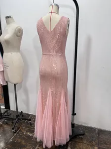Detailed back view of a sparkling pink sequined mermaid formal evening gown on mannequin
