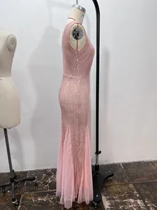 Detailed side view of a pink sequined mermaid evening gown displayed on a mannequin.
