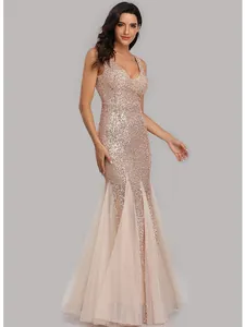 Elegant rose gold sequin mermaid evening gown with V-neck and tulle panels at hem.