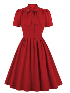 Front view of a red vintage-style dress with a bow tie collar and pleated skirt