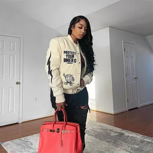 Detail of stylish apricot printed bomber jacket for women featuring graphic slogans