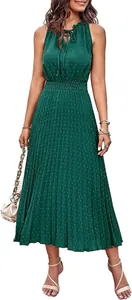 Full body view of a women's green Swiss dot midi dress featuring a pleated skirt design