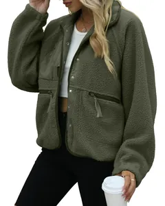 Close-up of olive green sherpa fleece jacket showing texture and zipper pocket details.
