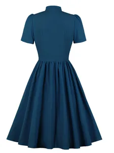 Back view of elegant vintage teal flare dress with high neck and puff sleeves.