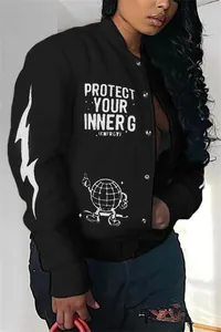 Detailed view of women's black varsity jacket featuring white graphic prints and ribbed cuffs