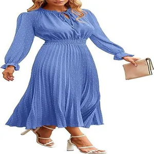 Detail view of blue long sleeve midi dress with Swiss dot fabric and pleated skirt