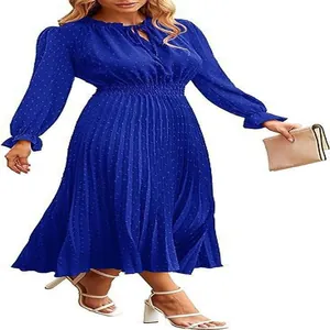 Detailed view of the royal blue Swiss dot pleated midi dress with long sleeves and smocked waist.