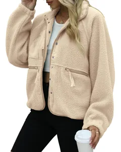 Close-up detail of women's warm beige sherpa fleece jacket featuring button closure
