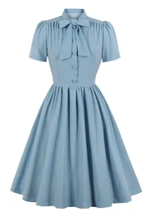 Elegant light blue A-line midi dress with bow tie collar and pleated skirt.